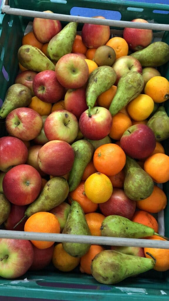 A crate of apples, pears and citrus fruit