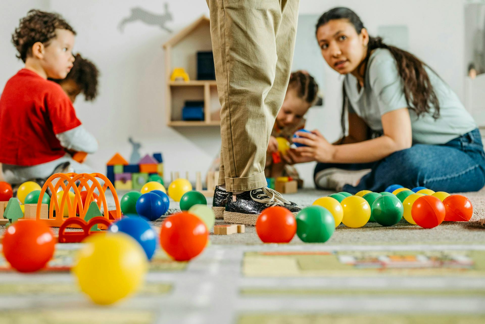 A family with two early years children surrounded by playtime toys